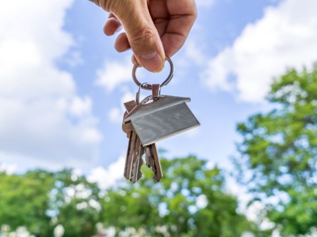 Real Estate agent holding house keys